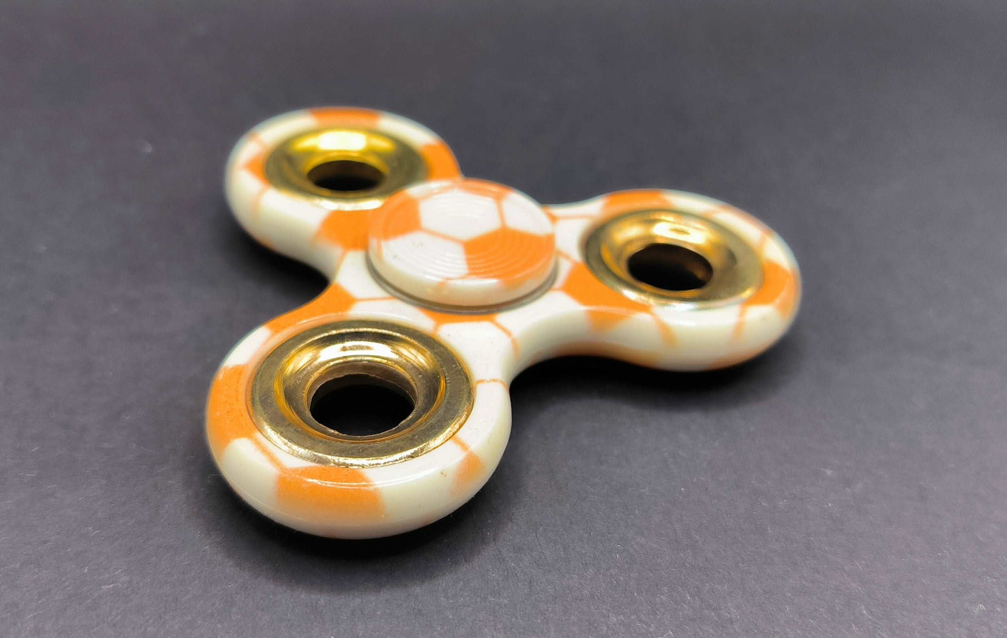 Fidget Sinner mit Kugellager Muster Fußball Orange Gold