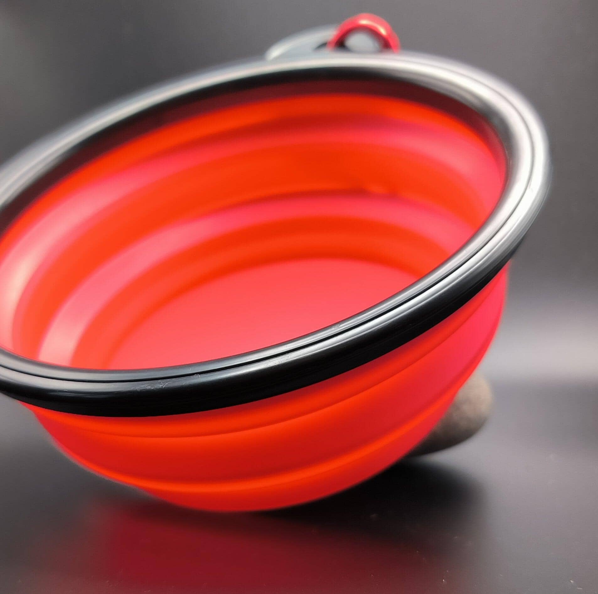 a close up of a red bowl on a table 